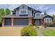 Beautiful two-story home with brick and blue siding, large garage, and well-maintained landscaping at 7831 W 109Th Ave, Westminster, CO 80021
