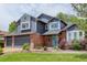 Charming two-story home featuring a brick facade, blue siding, and a well-kept lawn at 7831 W 109Th Ave, Westminster, CO 80021