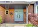 Close-up of front entrance showcasing brickwork, a light blue double door, and decorative planters at 7831 W 109Th Ave, Westminster, CO 80021