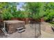Backyard featuring a hot tub enclosed by a protective fence, set on a stone base at 7831 W 109Th Ave, Westminster, CO 80021