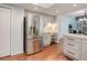 Spacious stainless steel refrigerator in a kitchen with hardwood floors and light gray cabinets at 7831 W 109Th Ave, Westminster, CO 80021