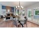 Open-concept living area with brick fireplace, modern lighting, and hardwood flooring at 7831 W 109Th Ave, Westminster, CO 80021