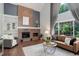 Cozy living room featuring a brick fireplace, large windows, and comfortable seating at 7831 W 109Th Ave, Westminster, CO 80021