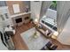 Living room with a brick fireplace, hardwood floors, and large windows to bring in natural light at 7831 W 109Th Ave, Westminster, CO 80021