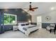 Main bedroom with a ceiling fan, carpet, and a bathroom, providing a comfortable retreat at 7831 W 109Th Ave, Westminster, CO 80021
