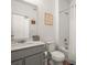 Well-lit bathroom with vanity, toilet, and shower/tub combo with white tile at 12580 Boggs St, Parker, CO 80134