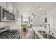 Contemporary kitchen with stainless appliances, a quartz island, and view to the living area at 12580 Boggs St, Parker, CO 80134