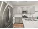 Modern kitchen with stainless steel appliances, sleek gray cabinets, and quartz countertops at 12580 Boggs St, Parker, CO 80134