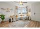 Bright living room with a large corner window offering natural light and stylish decor at 12580 Boggs St, Parker, CO 80134