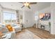 Cozy living room with wood floors, featuring a comfortable couch and staircase access at 12580 Boggs St, Parker, CO 80134
