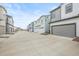 Street showcasing modern homes with attached garages and well-maintained landscaping at 12580 Boggs St, Parker, CO 80134