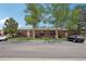 Exterior view of a brick apartment building with parking lot and landscaped surroundings at 3663 S Sheridan Blvd # H15, Denver, CO 80235