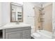 Clean bathroom features a shower over tub, white tile, and a modern vanity with ample storage at 3663 S Sheridan Blvd # H15, Denver, CO 80235