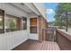 Exterior features a small private porch with brick and wood accents under a bright blue sky at 3663 S Sheridan Blvd # H15, Denver, CO 80235