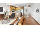 Open floor plan with kitchen, dining area, and cozy living room showcasing light wood floors at 3663 S Sheridan Blvd # H15, Denver, CO 80235