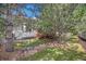 Charming backyard with mature trees and a ground cover offers a serene outdoor setting at 7410 Winter Berry Ln, Castle Pines, CO 80108