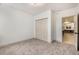 A cozy bedroom with a closet, soft carpet, and neutral tones offers a peaceful and inviting atmosphere at 7410 Winter Berry Ln, Castle Pines, CO 80108