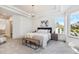 Spacious bedroom with natural light, a comfortable bed, and stylish furniture at 7410 Winter Berry Ln, Castle Pines, CO 80108