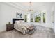 Bright bedroom with a tray ceiling, large windows, and a cozy, inviting atmosphere at 7410 Winter Berry Ln, Castle Pines, CO 80108