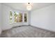 Bright bedroom features a bay window and neutral carpeting at 7410 Winter Berry Ln, Castle Pines, CO 80108