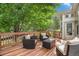 Inviting backyard deck with comfortable seating, perfect for outdoor relaxation and entertaining under the shade of mature trees at 7410 Winter Berry Ln, Castle Pines, CO 80108