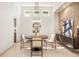 Dining area with a round wooden table, modern chairs, and a stylish sideboard at 7410 Winter Berry Ln, Castle Pines, CO 80108