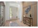 Modern entryway featuring sleek wood accents, a stylish table, and neutral decor at 7410 Winter Berry Ln, Castle Pines, CO 80108