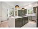Bright kitchen featuring a spacious center island, stainless steel appliances, and a breakfast nook at 7410 Winter Berry Ln, Castle Pines, CO 80108