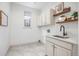 Well-lit laundry room with storage, shelving, a sink, and stylish accents at 7410 Winter Berry Ln, Castle Pines, CO 80108