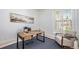 Bright office space with a wooden desk, accent chair, and natural light at 7410 Winter Berry Ln, Castle Pines, CO 80108