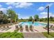Beautiful community pool with plenty of chairs for relaxing on a sunny day at 7410 Winter Berry Ln, Castle Pines, CO 80108