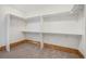 Spacious walk-in closet with ample shelving and custom wood base for sophisticated storage solutions at 7410 Winter Berry Ln, Castle Pines, CO 80108