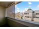 Balcony view overlooking neighboring townhomes, green space, and trees at 90 S Fraser Cir, Aurora, CO 80012