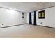 Unfinished basement with neutral carpet, white walls, and natural light at 90 S Fraser Cir, Aurora, CO 80012