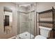 Bathroom featuring a glass-door shower with tiled walls and a convenient storage shelf at 90 S Fraser Cir, Aurora, CO 80012