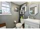 This bathroom features a modern vanity, stylish mirror, and decorative wall shelves at 90 S Fraser Cir, Aurora, CO 80012