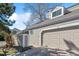 Exterior showcasing the home's architectural details, two-car garage, and decorative window at 90 S Fraser Cir, Aurora, CO 80012