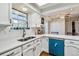 This kitchen features white countertops and cabinets with a stainless steel sink with wood floors at 90 S Fraser Cir, Aurora, CO 80012