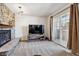 Living room features a stone fireplace, a decorative accent wall, and sliding door access to the balcony at 90 S Fraser Cir, Aurora, CO 80012