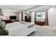 Spacious main bedroom featuring a mirrored wall, ample natural light, and neutral decor at 90 S Fraser Cir, Aurora, CO 80012