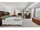 Generous main bedroom with fireplace, sitting area, mirrored wall, and neutral color palette at 90 S Fraser Cir, Aurora, CO 80012