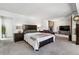 Bright main bedroom features a stone fireplace, sitting area, and dark wood furnishings at 90 S Fraser Cir, Aurora, CO 80012