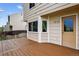 Outdoor deck area with beige siding and an exterior door, perfect for relaxation at 5337 S Ukraine Way, Aurora, CO 80015