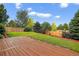 Beautiful backyard featuring a wood deck, lush green lawn, and privacy fence perfect for outdoor enjoyment at 5337 S Ukraine Way, Aurora, CO 80015