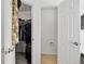 View of two closets, one open with clothes hanging and the other with a toilet paper holder at 5337 S Ukraine Way, Aurora, CO 80015