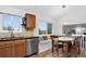 Dining area with breakfast nook and beautiful view from a large window at 5337 S Ukraine Way, Aurora, CO 80015