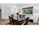 Bright dining room with wood floors, an open staircase, and a large window for natural light at 5337 S Ukraine Way, Aurora, CO 80015