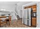 Open floor plan view of dining room and staircase with stainless steel refrigerator at 5337 S Ukraine Way, Aurora, CO 80015