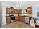 Well-appointed kitchen with stainless steel appliances and a cozy dining nook by the window at 5337 S Ukraine Way, Aurora, CO 80015