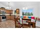 Bright, airy kitchen features a breakfast nook, stainless appliances, and wood floors at 5337 S Ukraine Way, Aurora, CO 80015